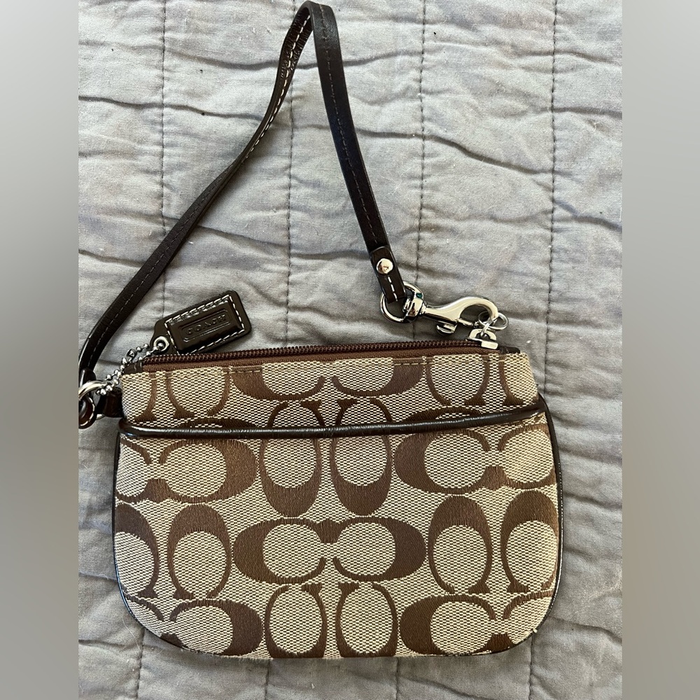 New without tags - never used COACH logo wristlet with RARE Purple lining.